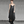 Load image into Gallery viewer, Women wearing a black, sheer & flowy bohemian open back dress paired with nouveau style brass earrings & pendant necklace.