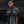 Load image into Gallery viewer, women standing in front of a black rock wearing a black and white tie dye linen scarf with leather tassels