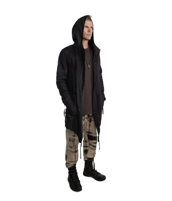 light weight linen parka. Featuring large lined hood, hidden snaps over front zip fastening, long sleeves with ribbed detail, Unisex parka made of light weight linen. Featuring large lined hood, hidden snaps over front zip fastening, long sleeves with ribbed detail, snaps on cuffs, a drawstring waist, front frayed edge pockets, leather detail on cuffs, collar and back, leather tassel zip on outside chest pocket, earphone loop on inside chest pocket, a drawstring hem and a mid-length.