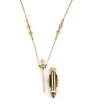 Gold necklace with a decorative pendant on a white background